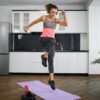 Fit young woman jumping at home